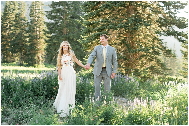 engagements, sunlight, mountains, wildflowers, mountain engagments, summer engagements, hair goals, engagement dresses, floral dress, grey suit, www.kristinacurtisphotography.com