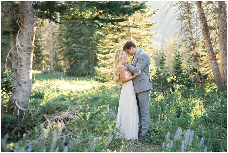 engagements, sunlight, mountains, wildflowers, mountain engagments, summer engagements, hair goals, engagement dresses, floral dress, grey suit, www.kristinacurtisphotography.com